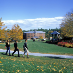 Description: A photograph of the Franklin Pierce University campus with students walking around the grounds.