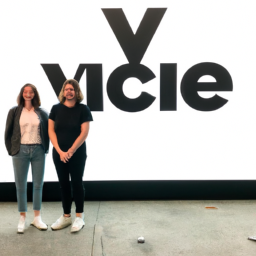 A photo of the two co-chief executives of Vice Media, Rachel Miller and Morgan Hertzan, standing in front of the company's logo.